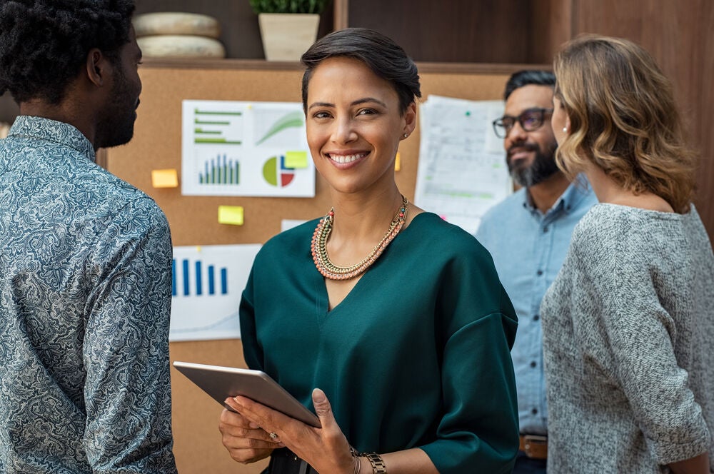 Business woman standing in front of graphs