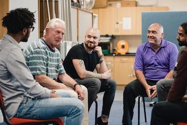 Group of men chatting and smiling
