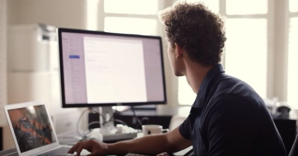 AFL player MItch Wallis sitting at his home desk studying his MBA