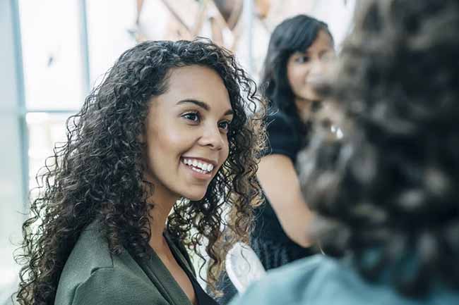 A woman engaged in conversation with a group of people.