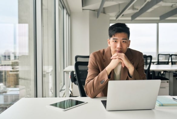 A prospective MBA student applying to an online MBA course using a laptop.