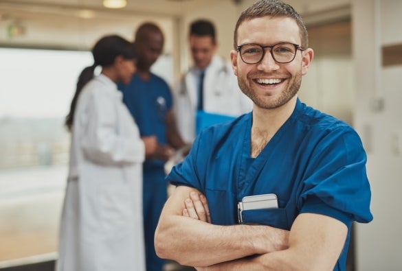 An informatics nurse crossing their arms and smiling.