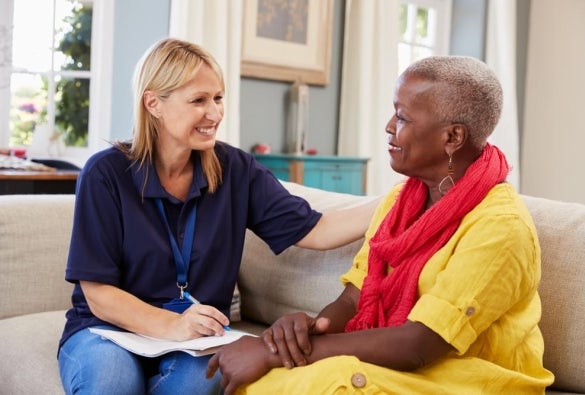 A mental health worker talking with a senior woman