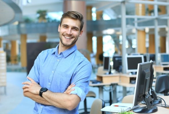 A health promotion professional smiling with arms crossed.