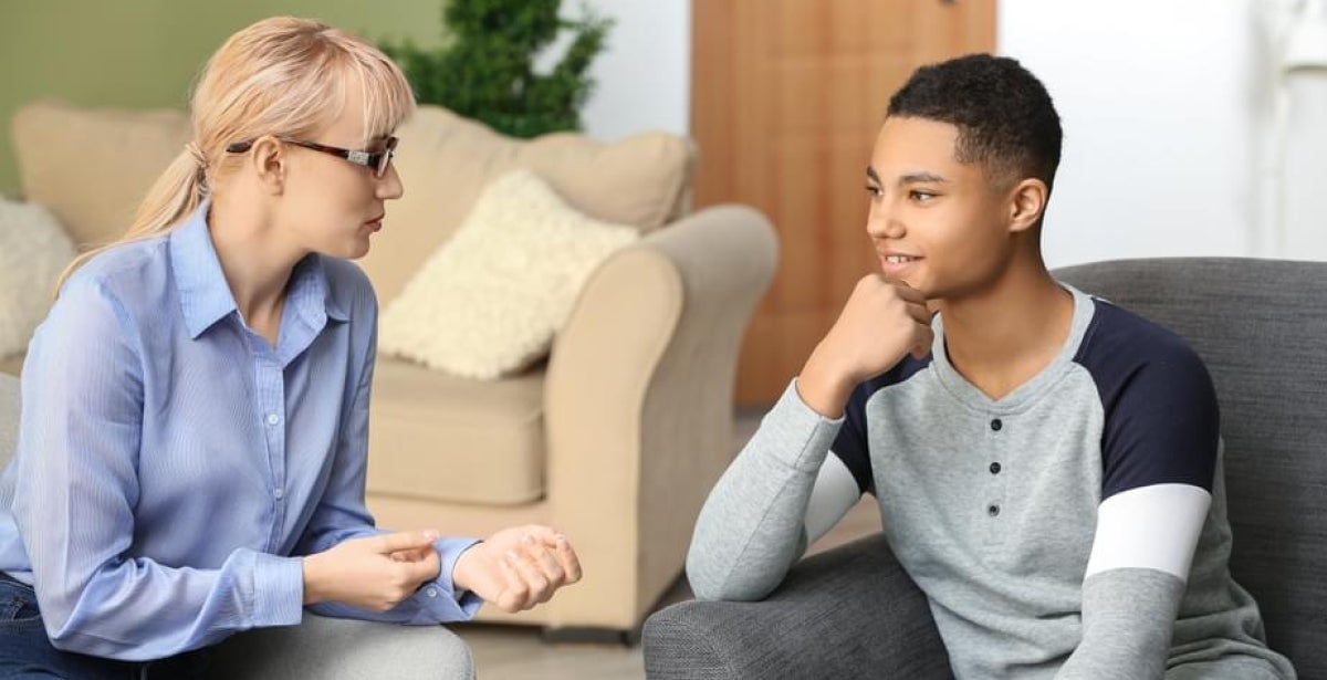 A child and adolescent mental health professional speaks with a teenager