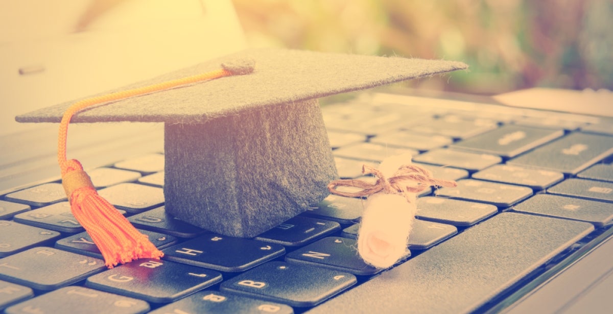 An MBA graduate cap on a laptop.