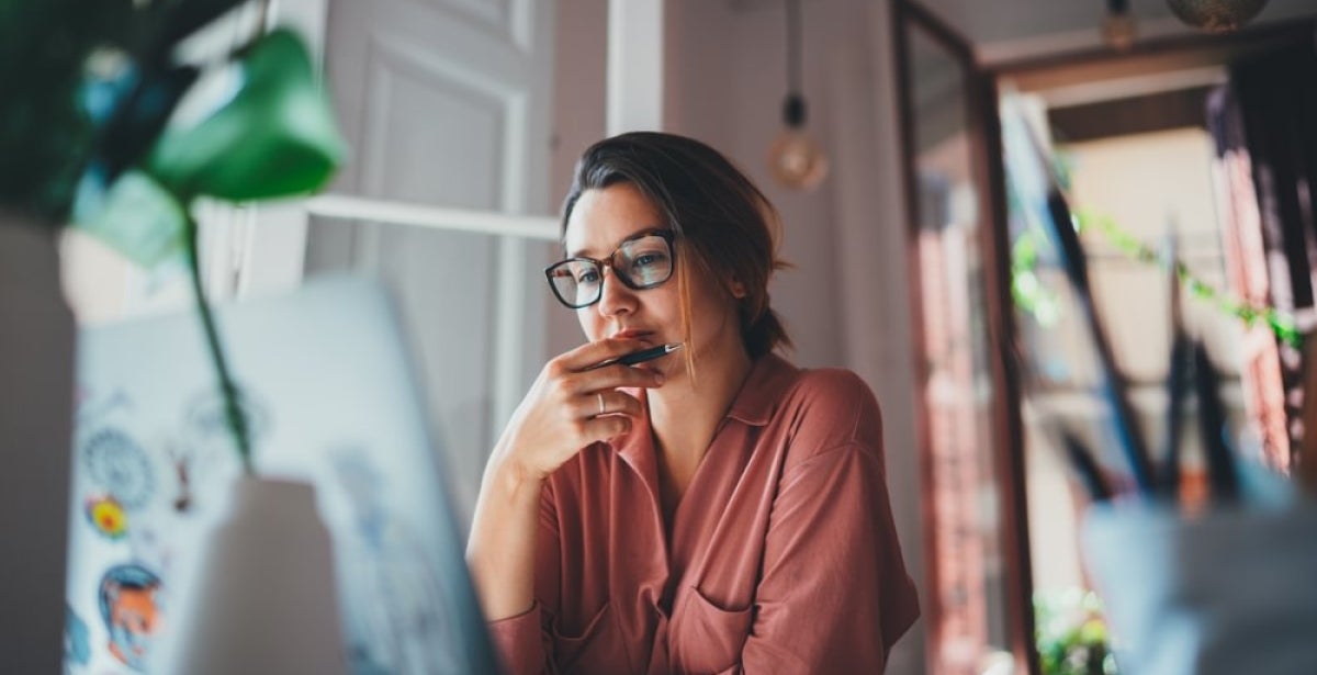 A woman planning her finances on her laptop.