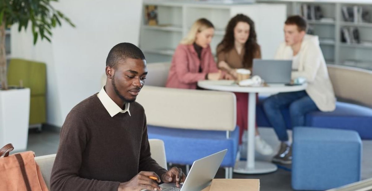 A financial planning student studies for the FASEA exam on their laptop.