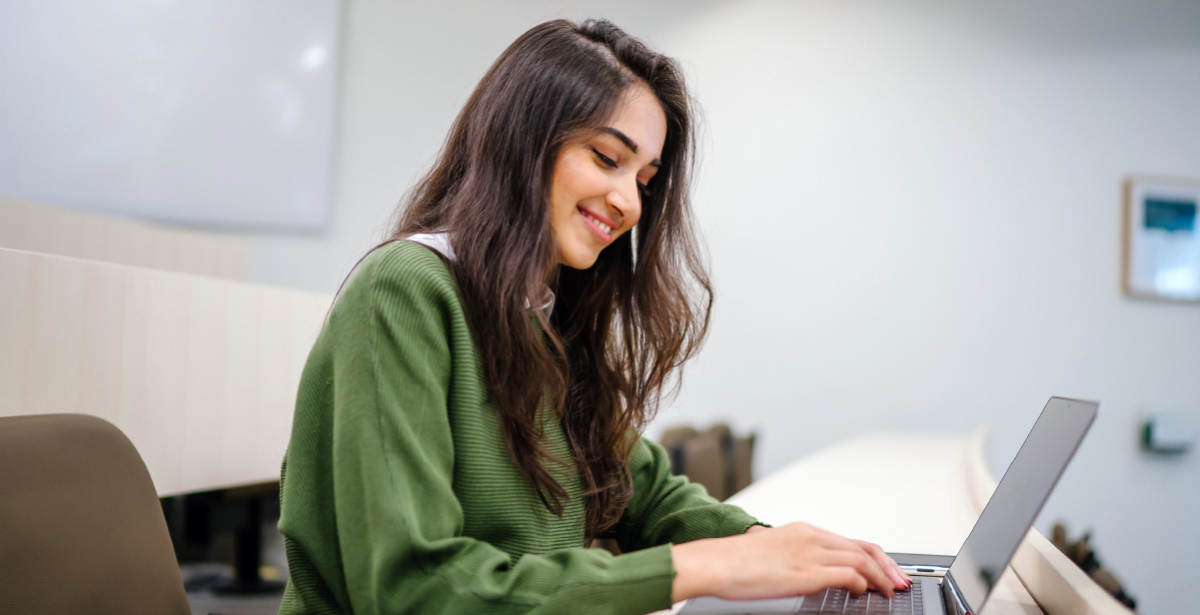 Women sitting at desk with laptop open