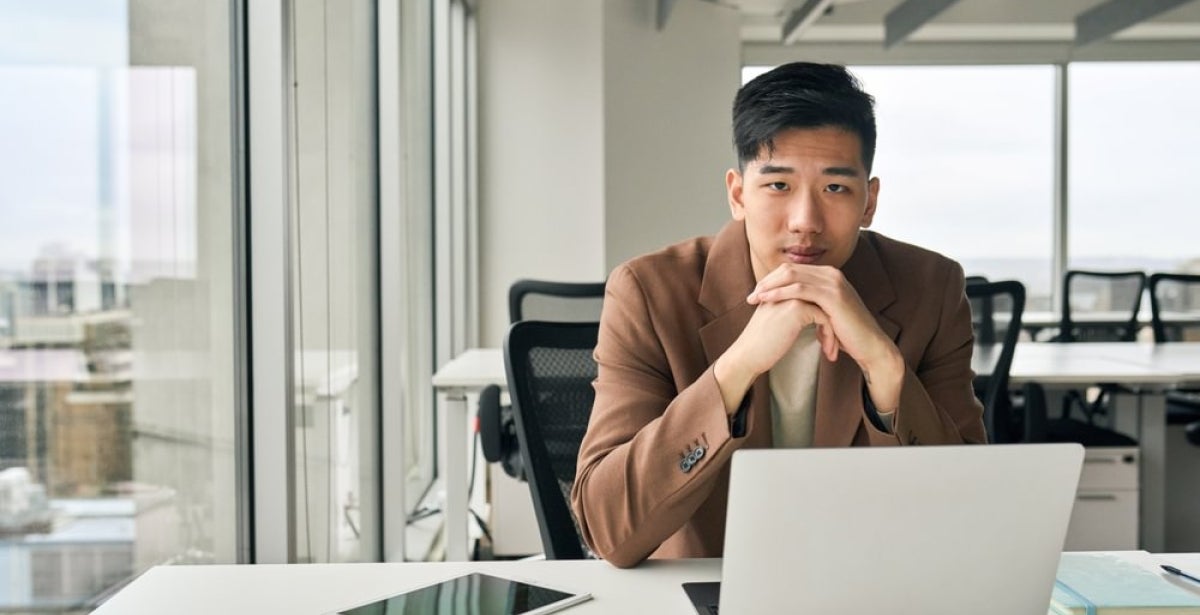 A prospective MBA student applying to an online MBA course using a laptop.