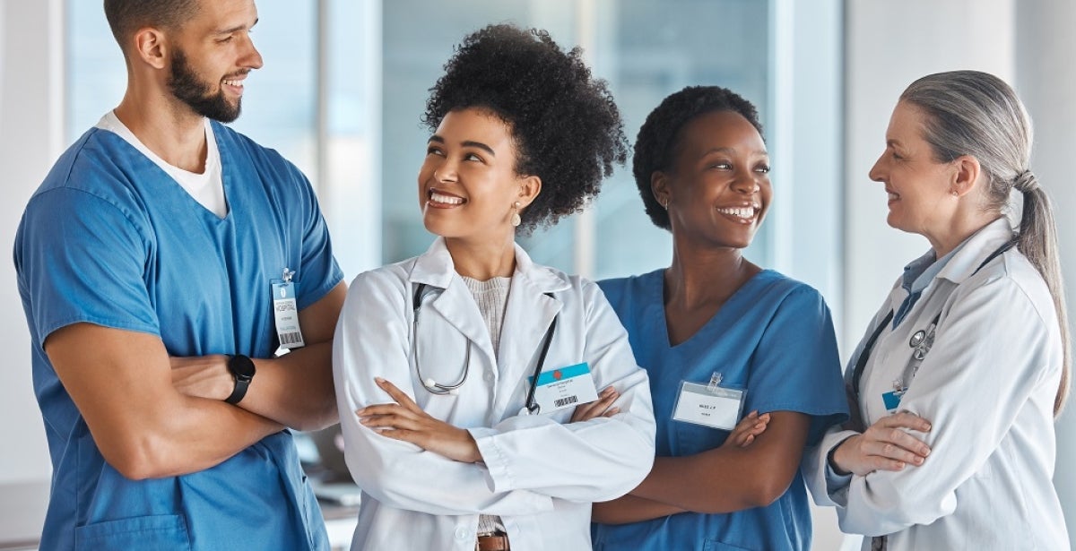 Team of medical professionals in a medical facility talking with each other.