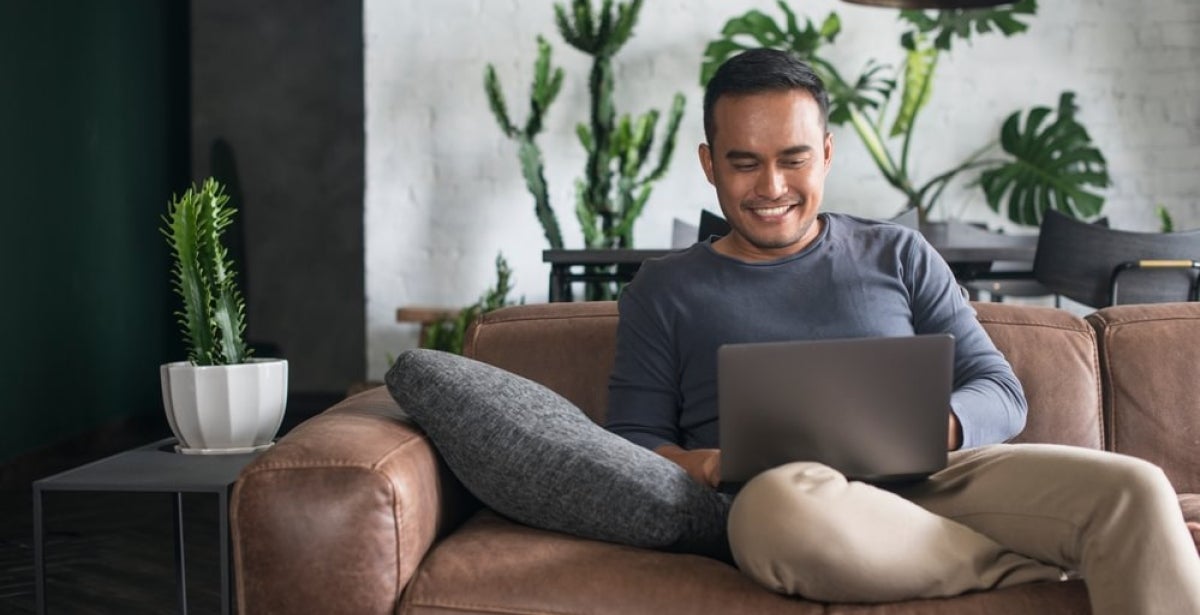 An MBA student studying online through his laptop remotely.