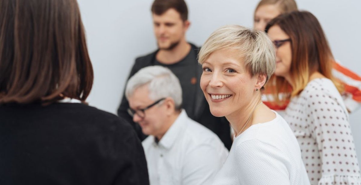 A global health leader smiling during a meeting.