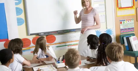Professional woman teaching a primary class and sharing why she transitioned into her new career.