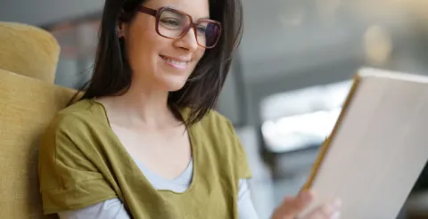 Girl smiling while working efficiently to achieve success through online university study programs.