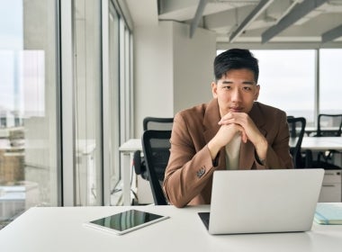 A prospective MBA student applying to an online MBA course using a laptop.