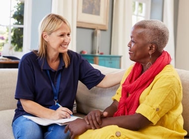 A mental health worker talking with a senior woman